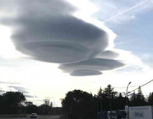 Not UFOs! Just Lenticular clouds, seen north of Madrid in Spain.